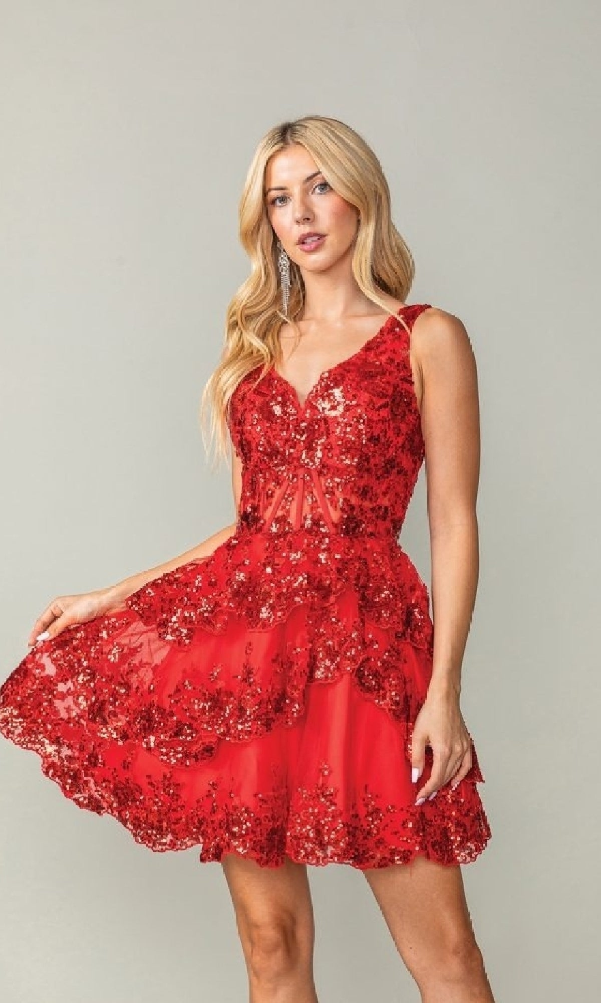 Woman wearing a red short a-line dress against a plain background